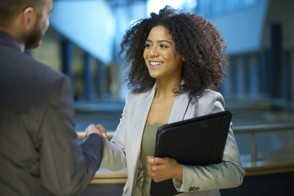 Female job applicant shaking hands